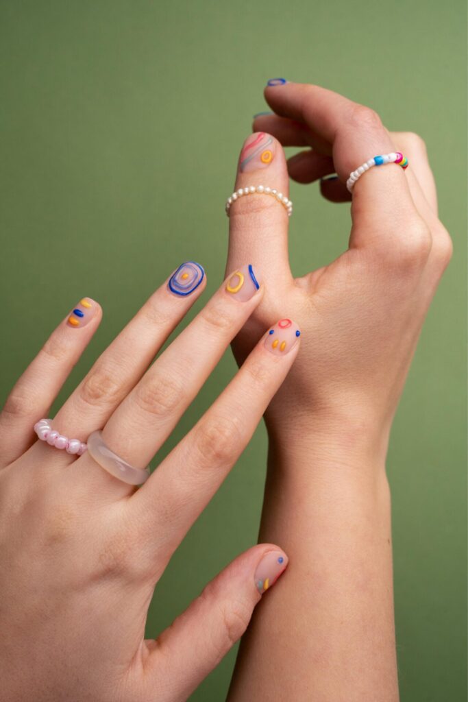 A hand with healthy, natural nails, showcasing smooth, clear, and well-maintained nails in a close-up view.