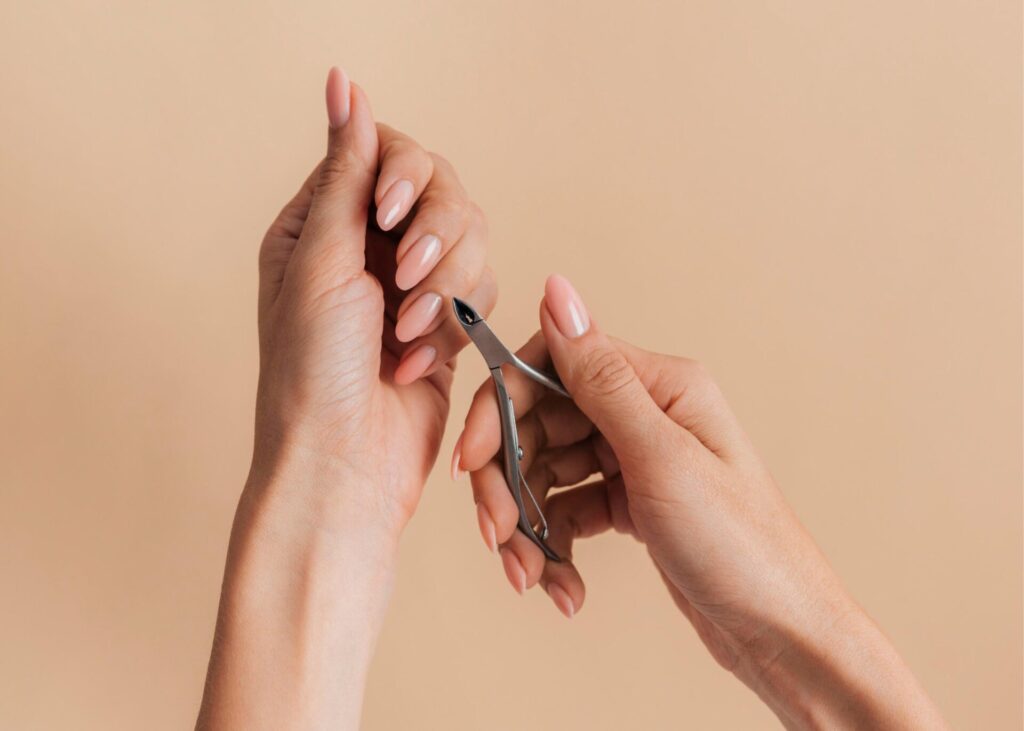 a person in the process of trimming her cuticles