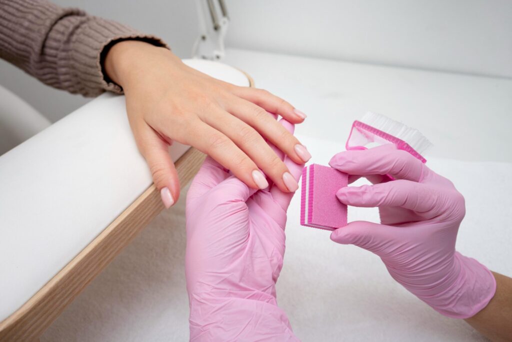 a professional working on a client's nail